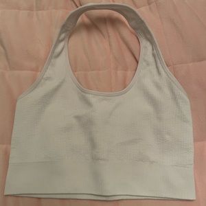 white NVGTN halter sports bra